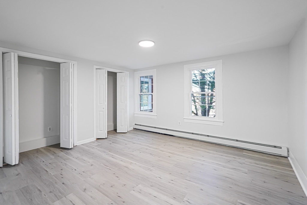 757 Main Street, Unit A Southbridge, MA 01550 - Photo 21 of 32 an empty room with wooden floor and windows