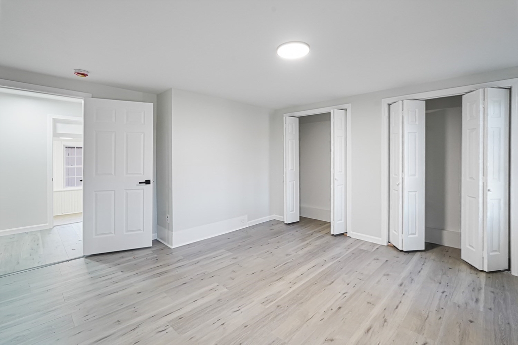 757 Main Street, Unit A Southbridge, MA 01550 - Photo 22 of 32 an empty room with wooden floor & windows