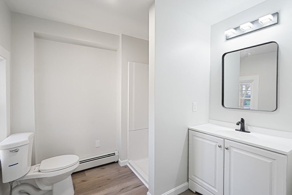 757 Main Street, Unit A Southbridge, MA 01550 - Photo 24 of 32 a bathroom with a toilet a sink and mirror