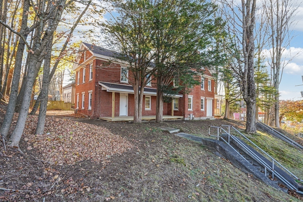 757 Main Street, Unit A Southbridge, MA 01550 - Photo 31 of 32 a house with trees in front of it