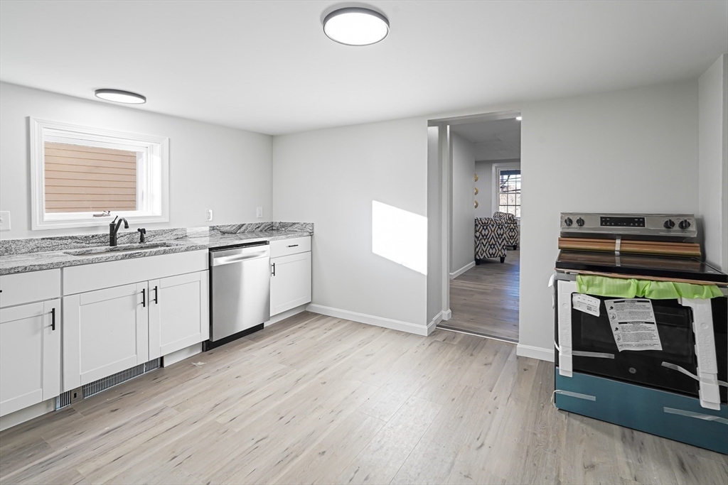 757 Main Street, Unit A Southbridge, MA 01550 - Photo 6 of 32 a kitchen with stainless steel appliances granite countertop a stove a sink and a microwave