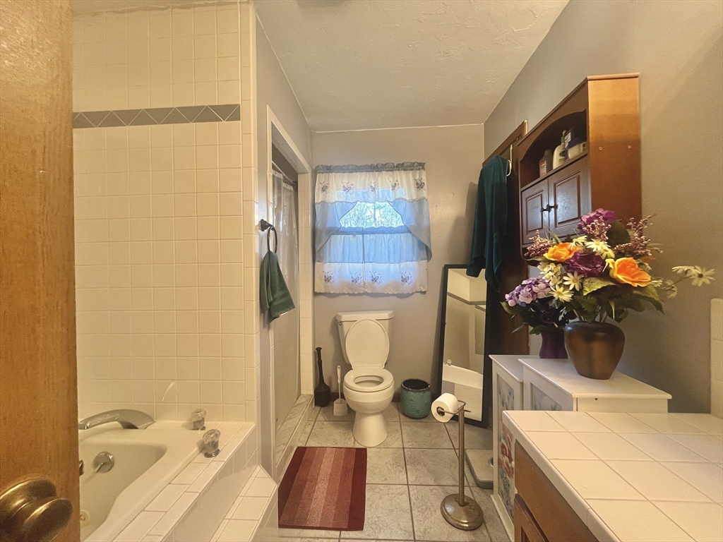 31 Putnam Road Sturbridge, MA 01566 - Photo 11 of 34 a bathroom with a sink mirror and a toilet