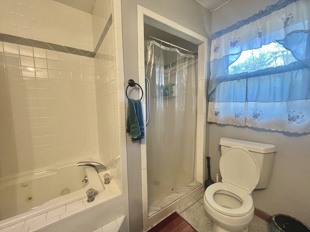 31 Putnam Road Sturbridge, MA 01566 - Photo 13 of 34 a bathroom with a toilet and a shower