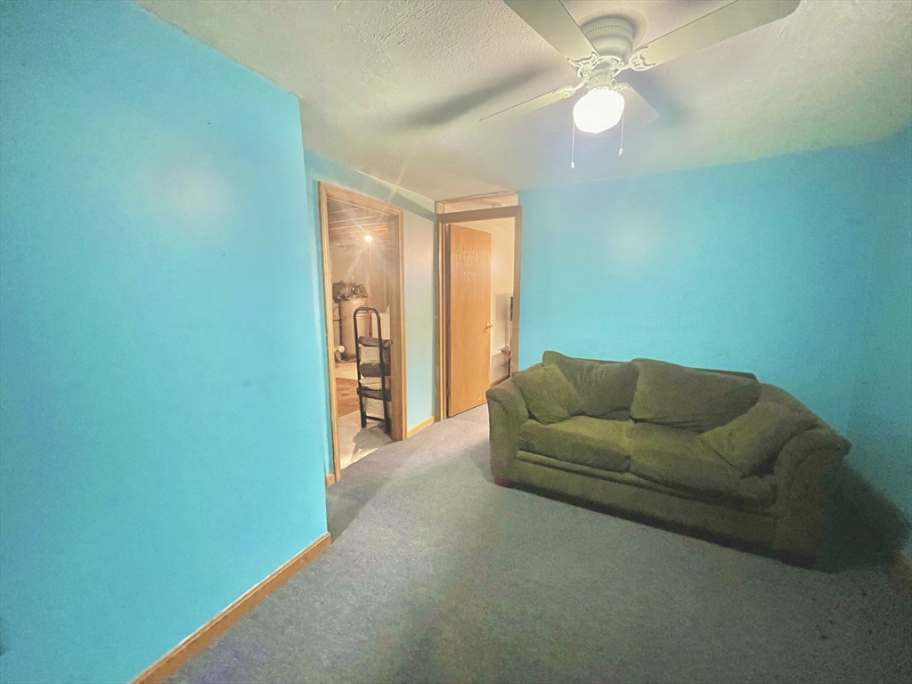 31 Putnam Road Sturbridge, MA 01566 - Photo 31 of 34 a living room with furniture and a ceiling fan