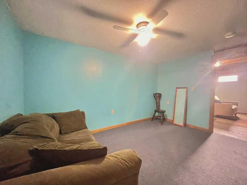 31 Putnam Road Sturbridge, MA 01566 - Photo 32 of 34 a living room with furniture and a chandelier