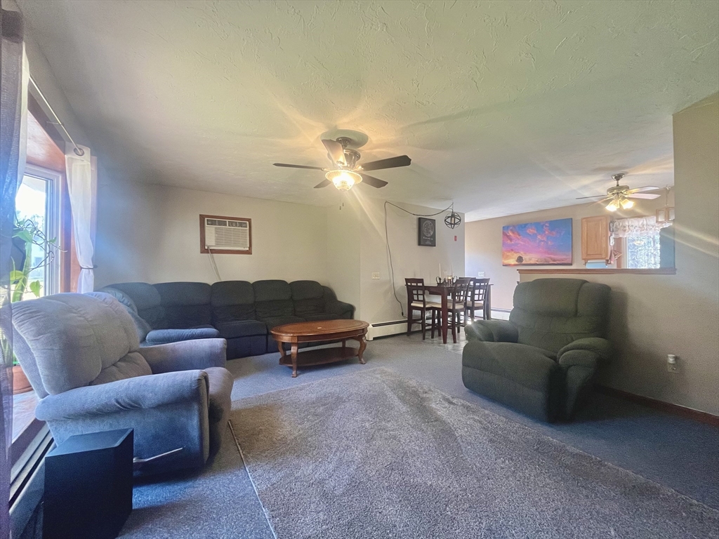 31 Putnam Road Sturbridge, MA 01566 - Photo 7 of 34 a living room with furniture a chandelier and a window