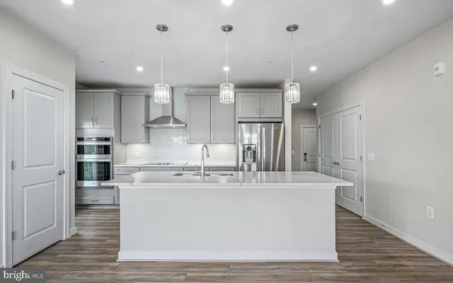 a large kitchen with stainless steel appliances