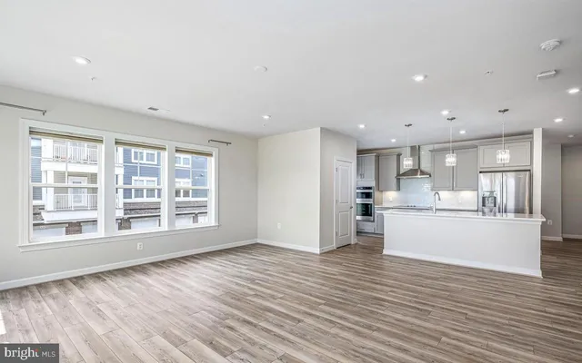 a view of a kitchen with kitchen island wooden floors wooden floor and center island