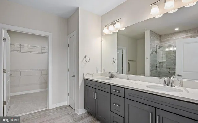 a bathroom with double vanity sinks and a mirror
