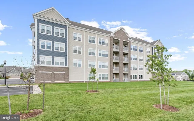 a front view of building with yard