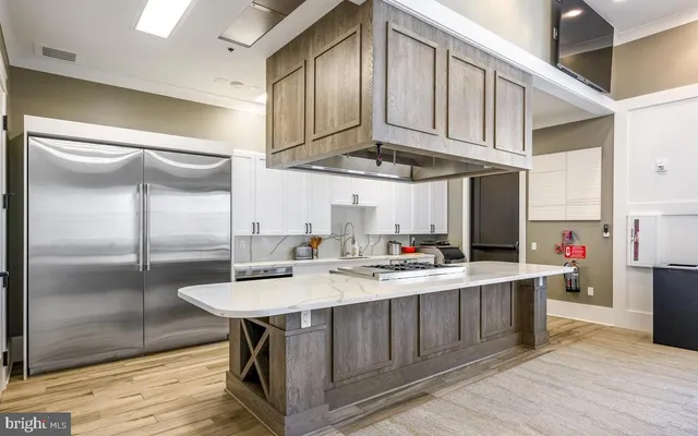 a kitchen with stainless steel appliances a sink a stove and refrigerator