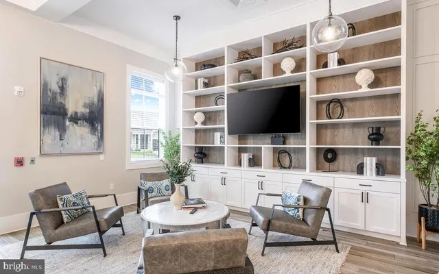 a view of a livingroom with furniture and a bookshelf