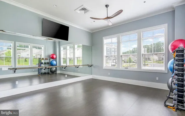 a view of a livingroom with furniture a flat screen tv and a large window