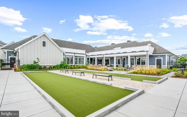 a view of an house with swimming pool and chairs