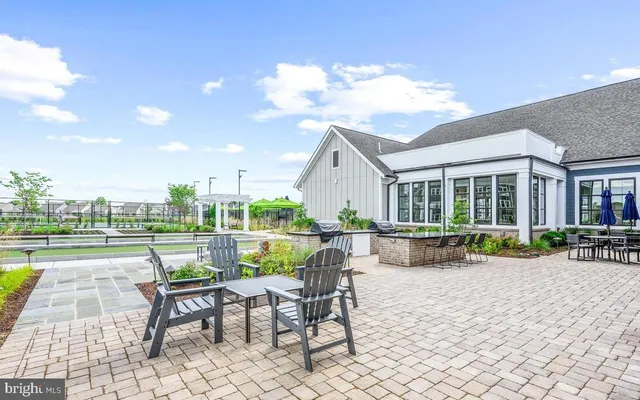 a swimming pool with outdoor seating and a garden