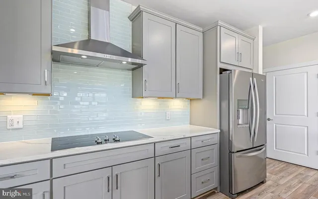 a kitchen with cabinets stainless steel appliances and a window