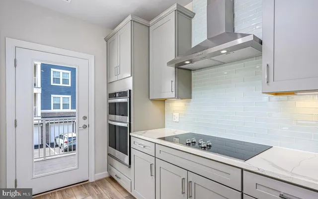 a kitchen with stainless steel appliances cabinets and a counter top space