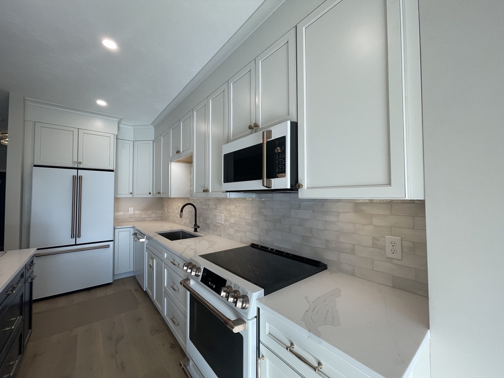 20 Coach Road South Easton, MA 01776 - Photo 7 of 11 a kitchen with stainless steel appliances granite countertop a sink stove and refrigerator