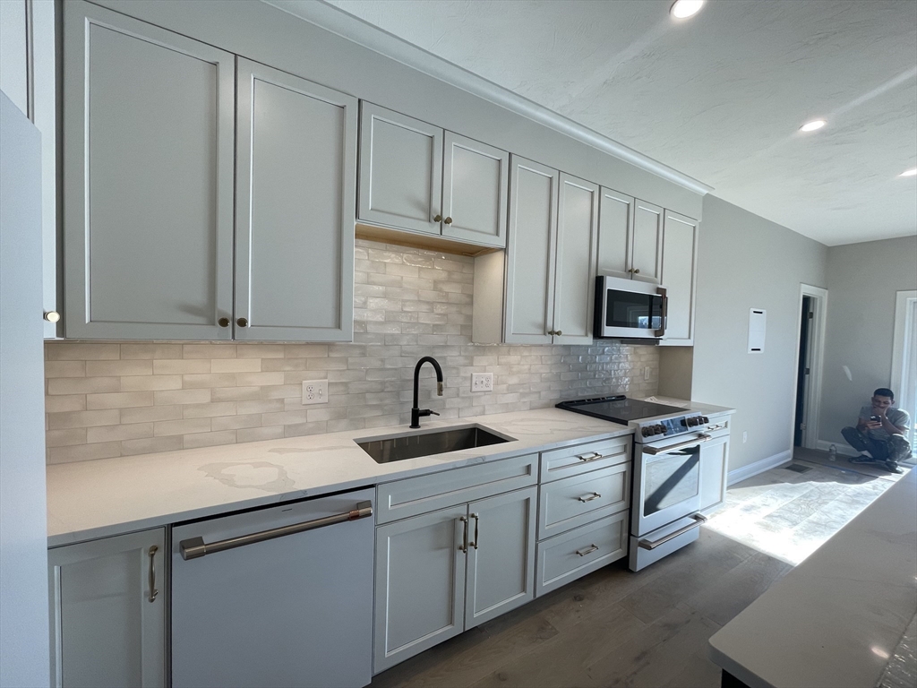 20 Coach Road South Easton, MA 01776 - Photo 8 of 11 a kitchen with stainless steel appliances granite countertop a sink stove and cabinets