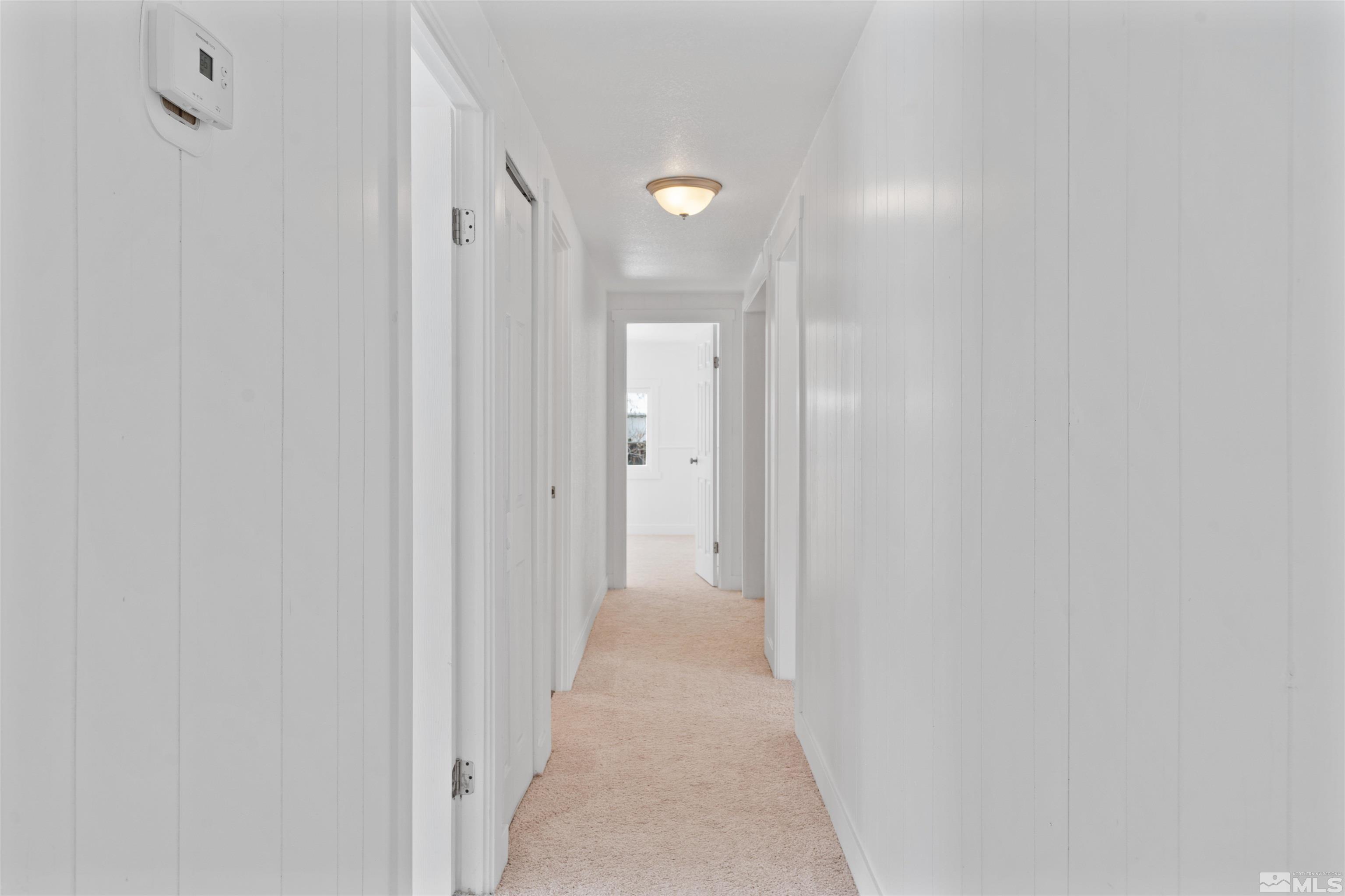 3993 Kiwi Court Reno, NV 89508 - Photo 17 of 39 a view of a hallway with wooden floor
