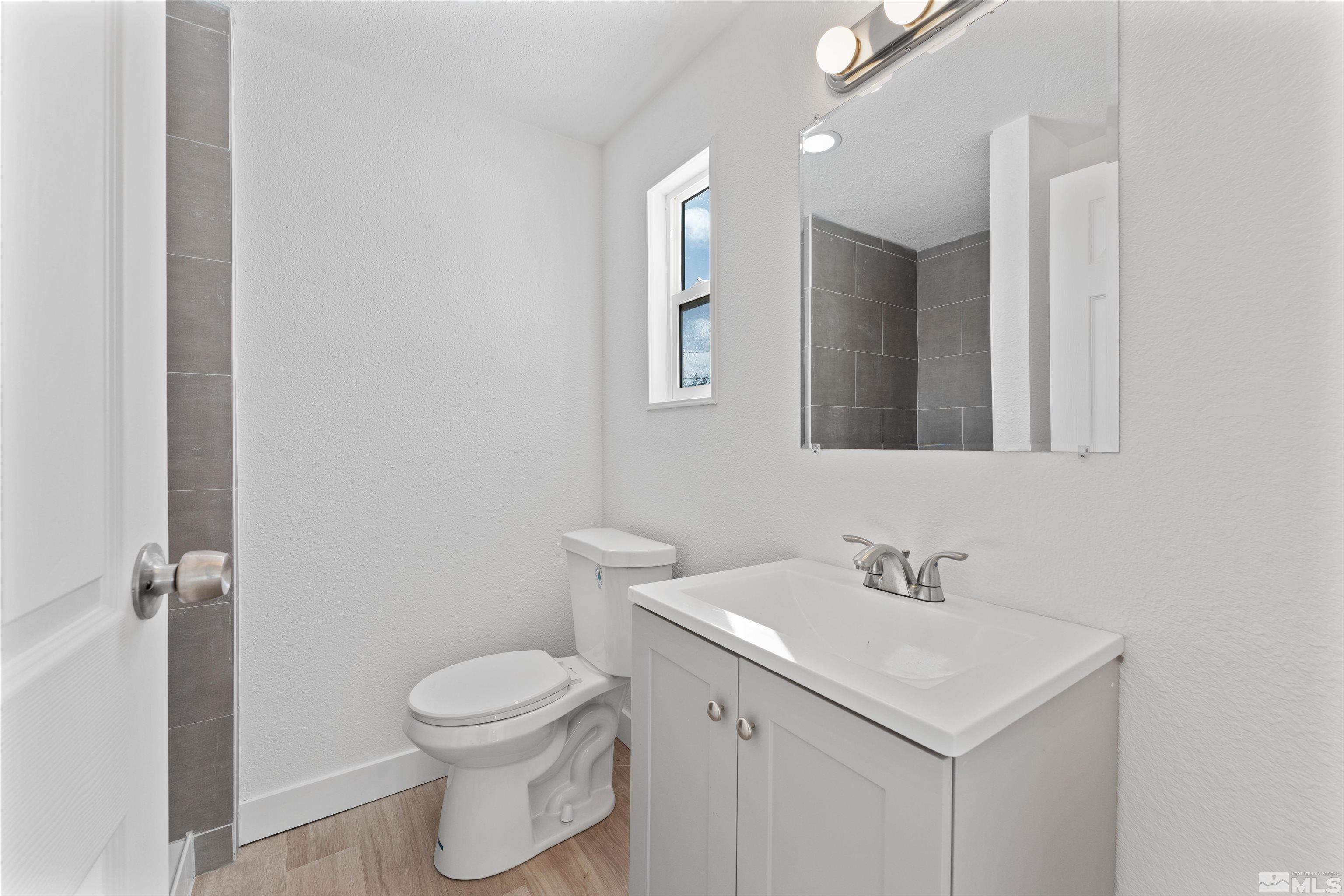 3993 Kiwi Court Reno, NV 89508 - Photo 23 of 39 a bathroom with a sink toilet and mirror