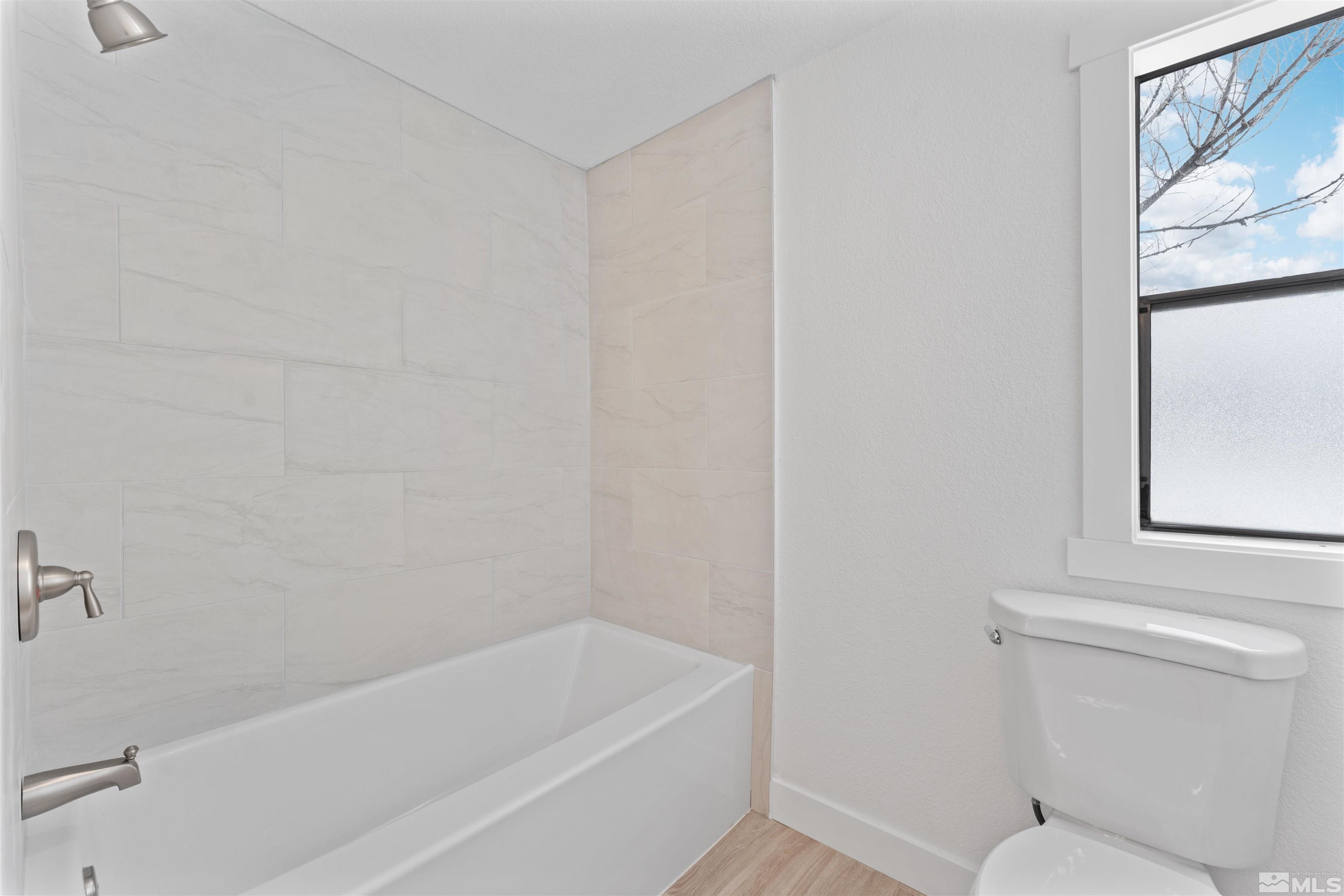 3993 Kiwi Court Reno, NV 89508 - Photo 25 of 39 a bathroom with a toilet and bathtub