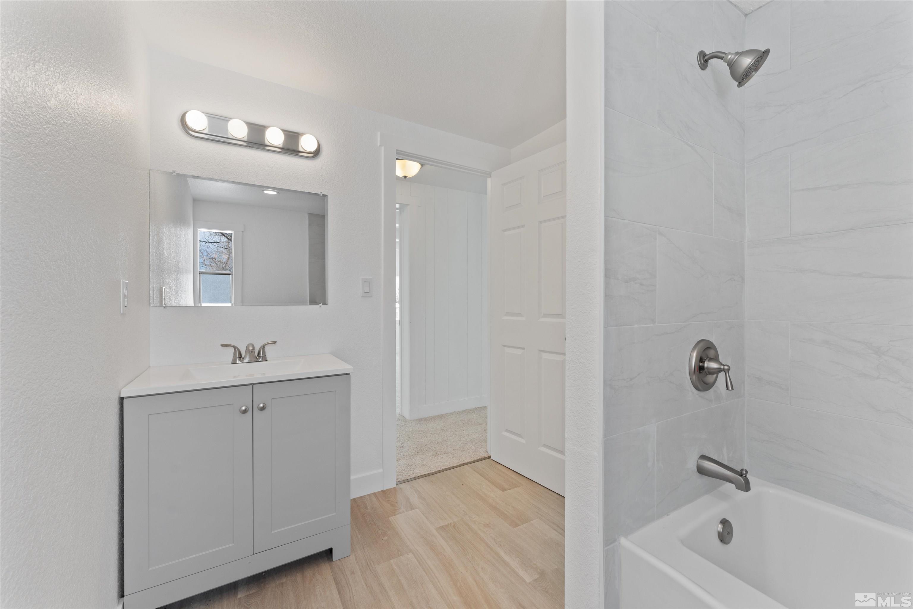 3993 Kiwi Court Reno, NV 89508 - Photo 26 of 39 a bathroom with a tub sink and mirror