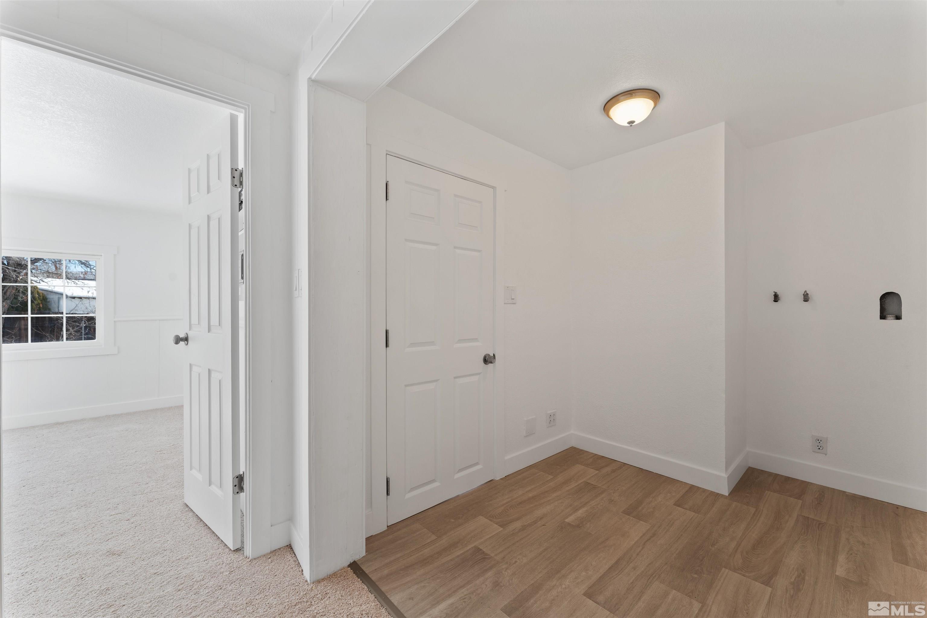 3993 Kiwi Court Reno, NV 89508 - Photo 29 of 39 an empty room with wooden floor and windows