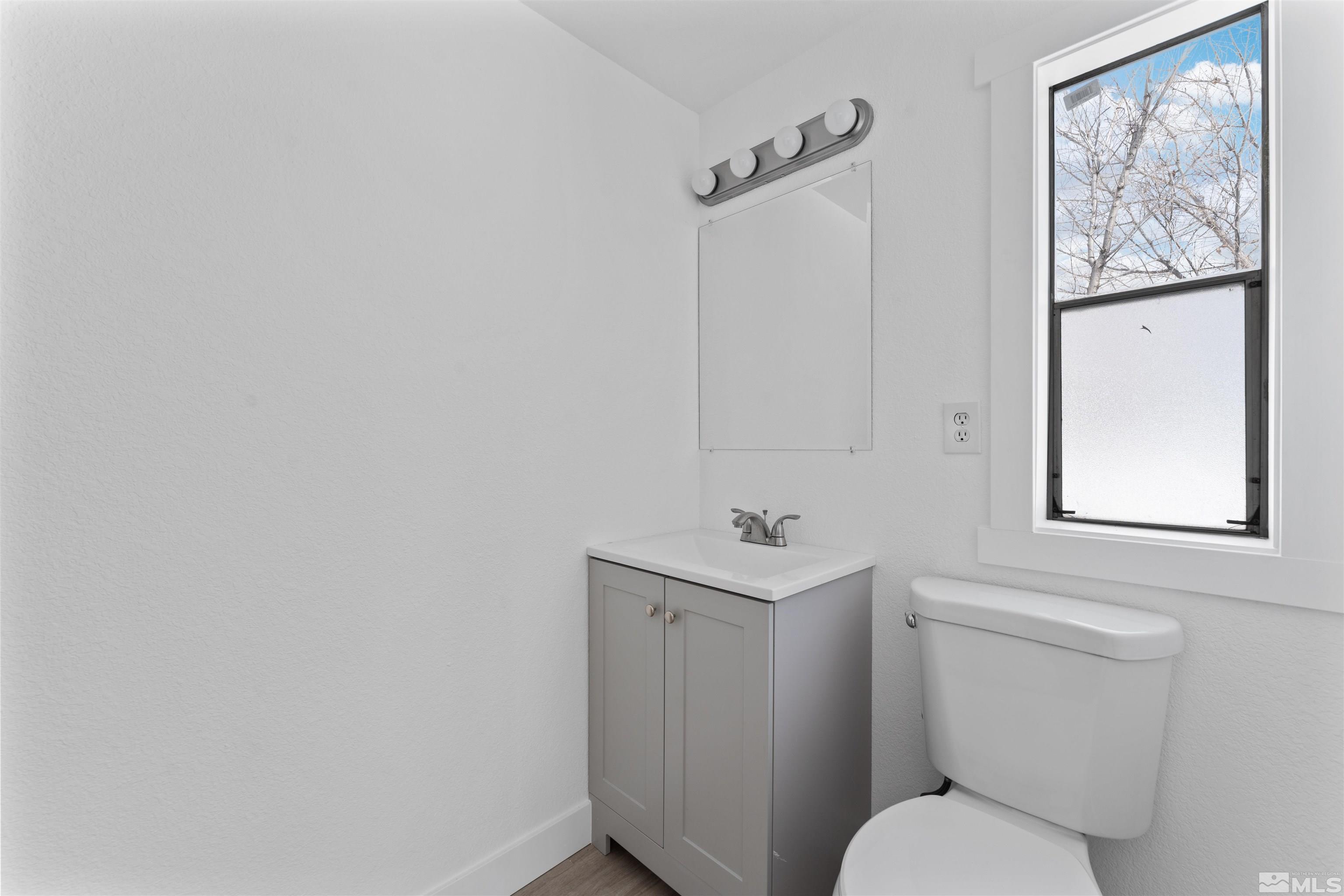 3993 Kiwi Court Reno, NV 89508 - Photo 33 of 39 a white toilet sitting next to a bathroom sink