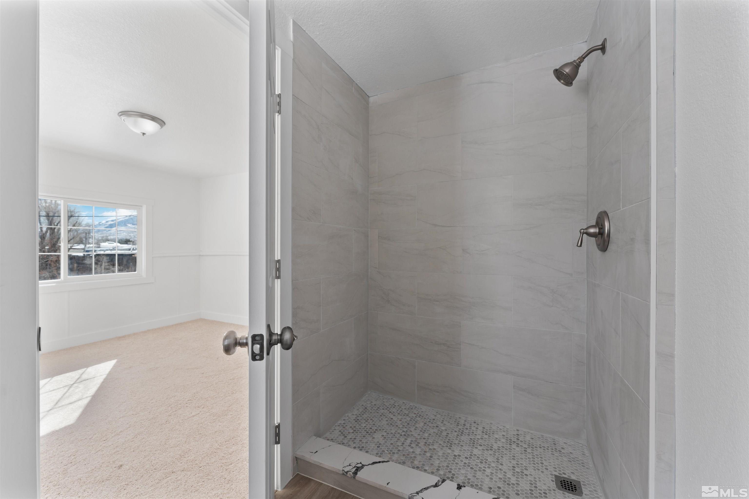 3993 Kiwi Court Reno, NV 89508 - Photo 34 of 39 a bathroom with a shower