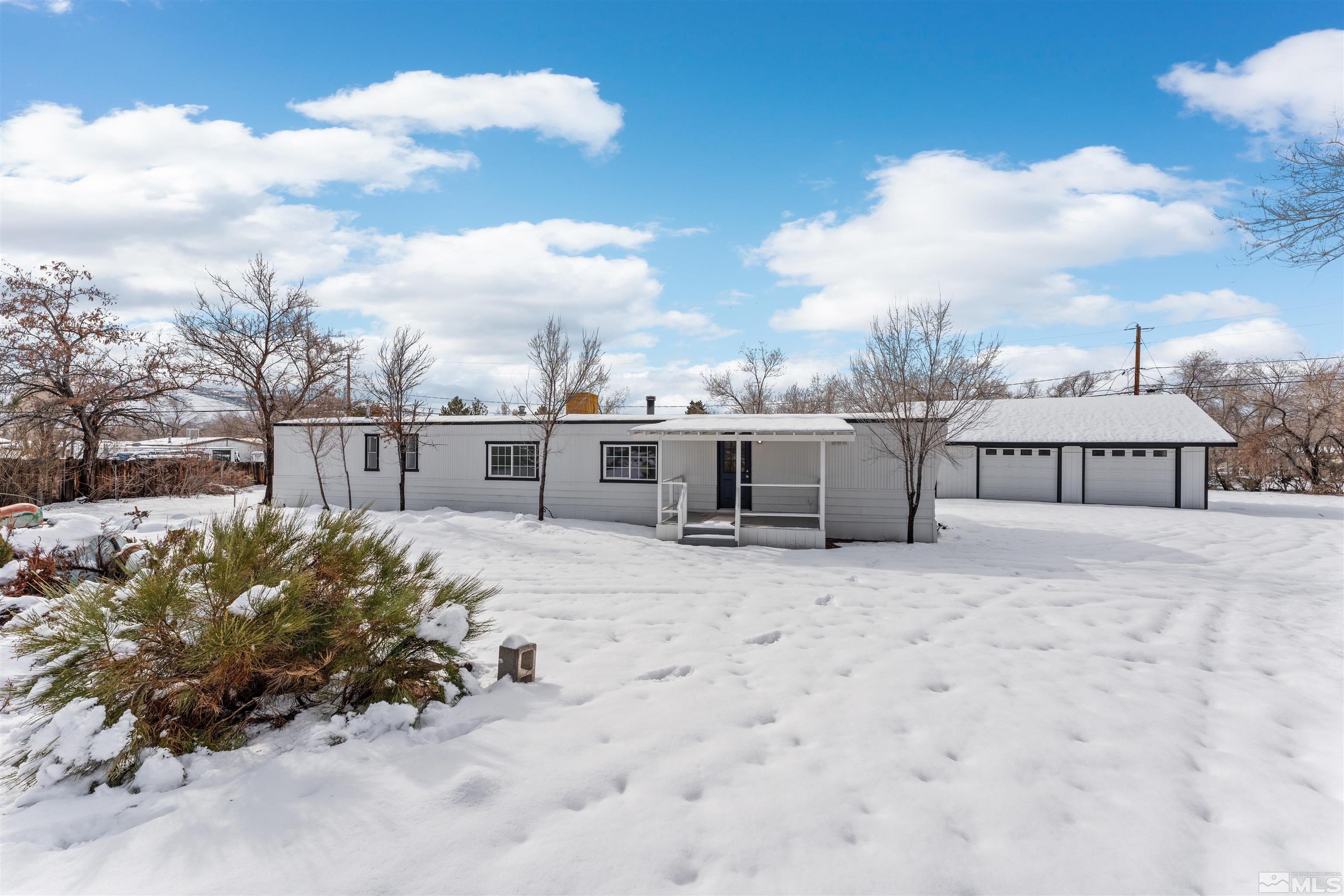 3993 Kiwi Court Reno, NV 89508 - Photo 4 of 39 a front view of a house with a yard