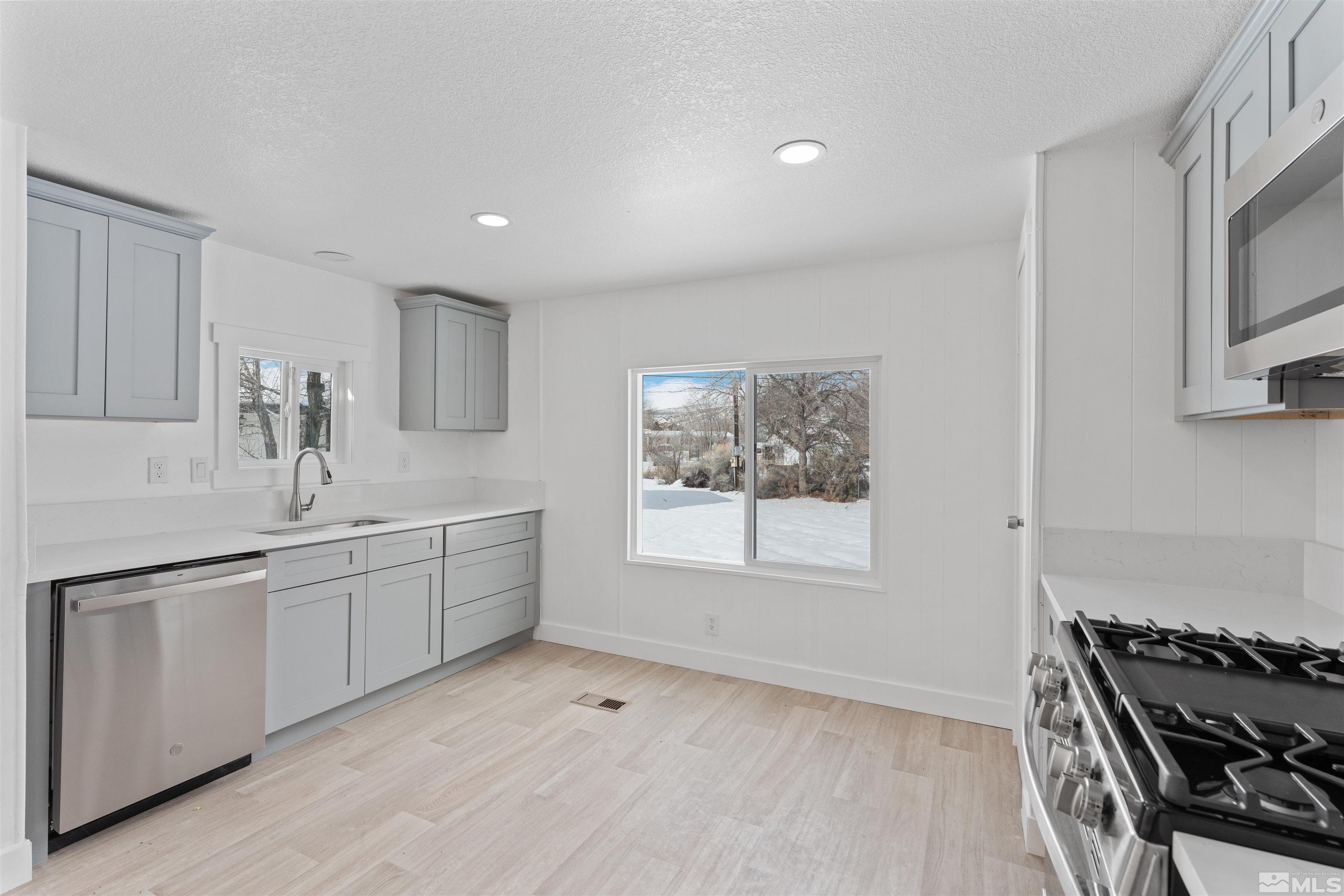 3993 Kiwi Court Reno, NV 89508 - Photo 7 of 39 a kitchen with sink and microwave