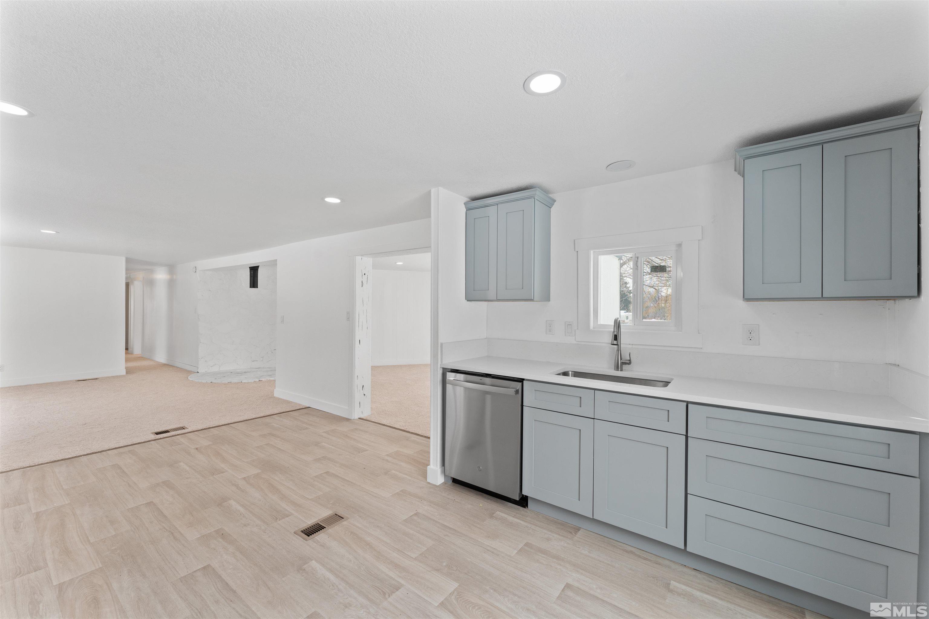 3993 Kiwi Court Reno, NV 89508 - Photo 8 of 39 a view of a kitchen with a sink cabinets and wooden floor