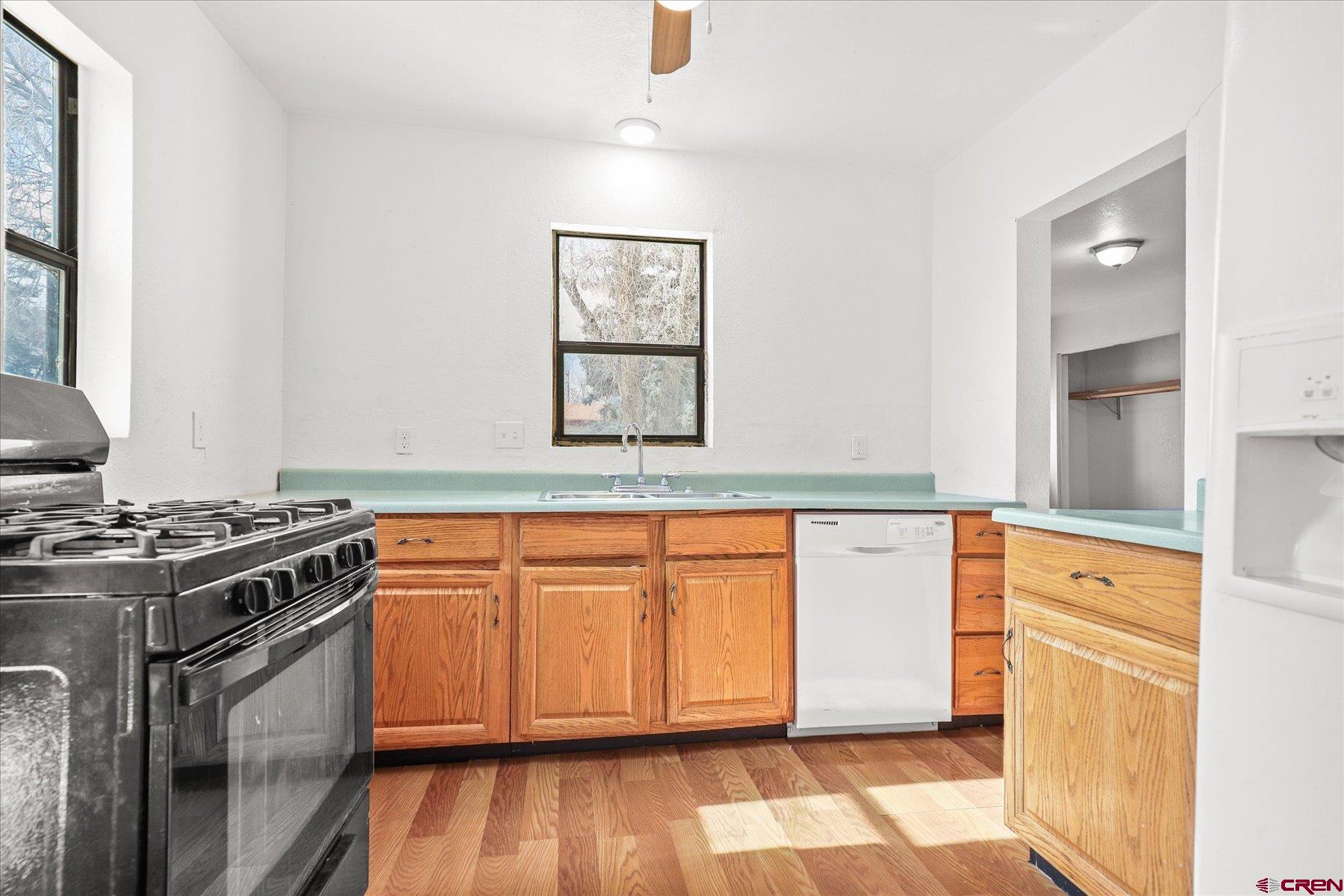 403 East 3rd Street Cortez, CO 81321 - Photo 11 of 31 a kitchen with stainless steel appliances granite countertop a stove and a refrigerator