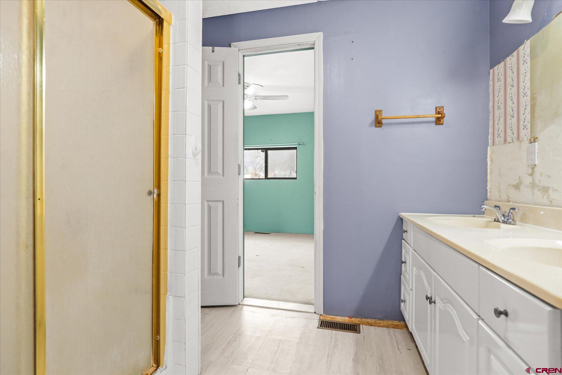 403 East 3rd Street Cortez, CO 81321 - Photo 17 of 31 a bathroom with a sink and a mirror
