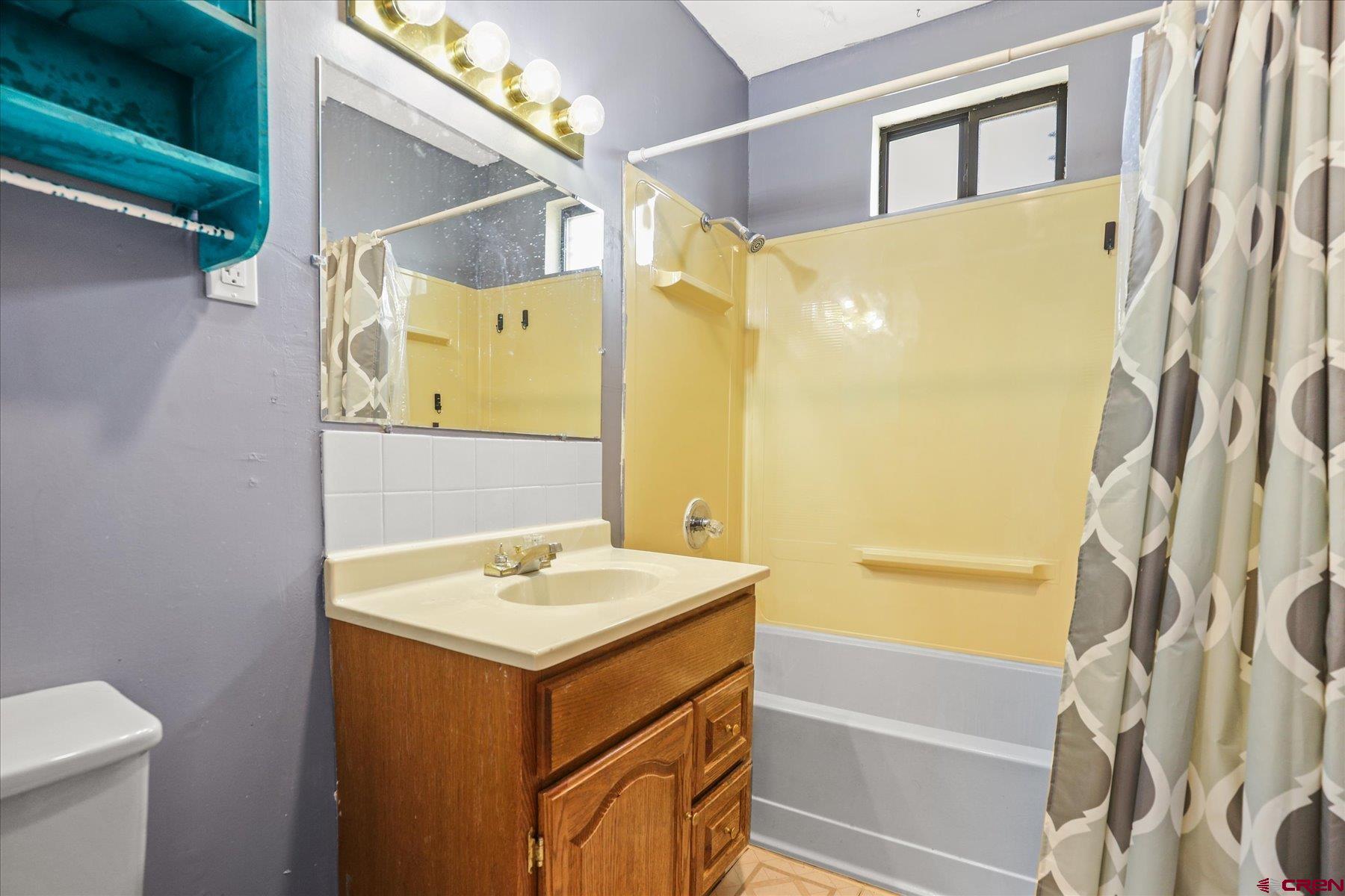 403 East 3rd Street Cortez, CO 81321 - Photo 20 of 31 a bathroom with a sink and a mirror