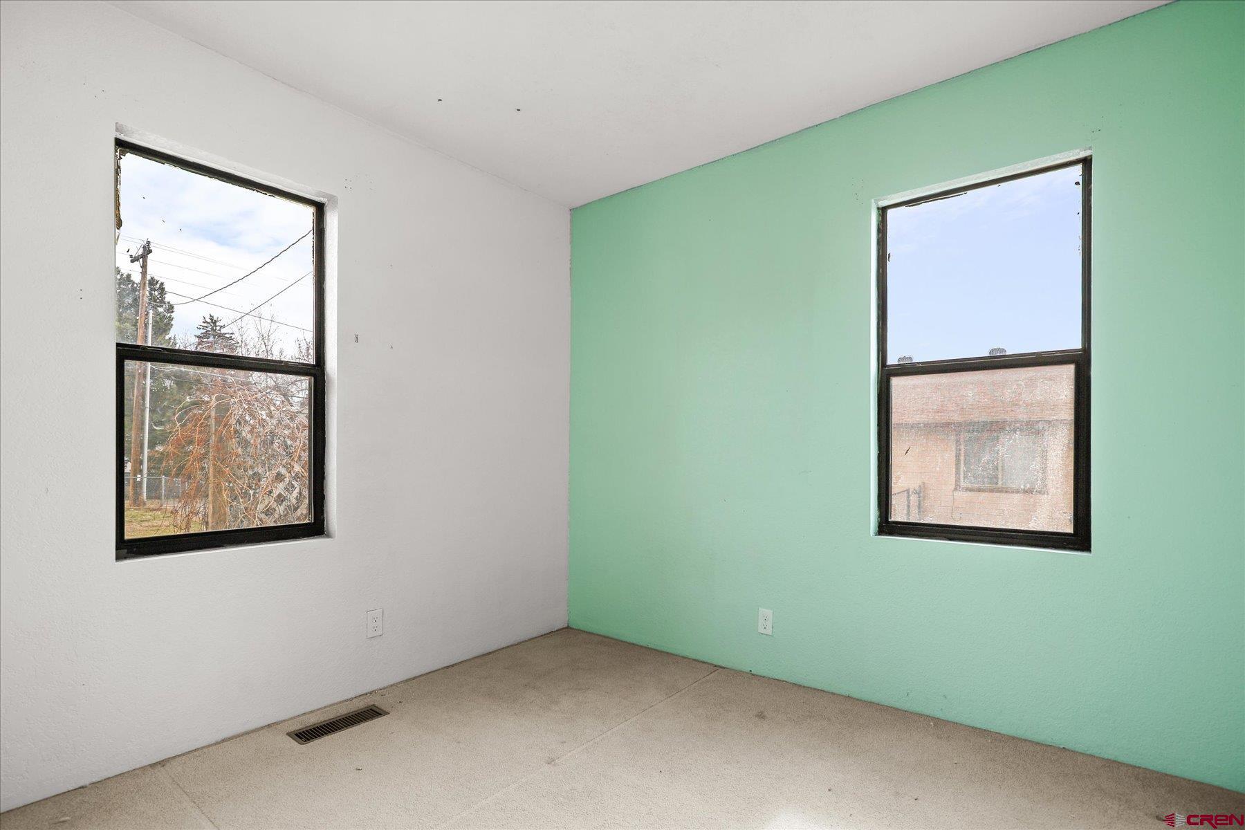 403 East 3rd Street Cortez, CO 81321 - Photo 22 of 31 a view of an empty room with window and mirror