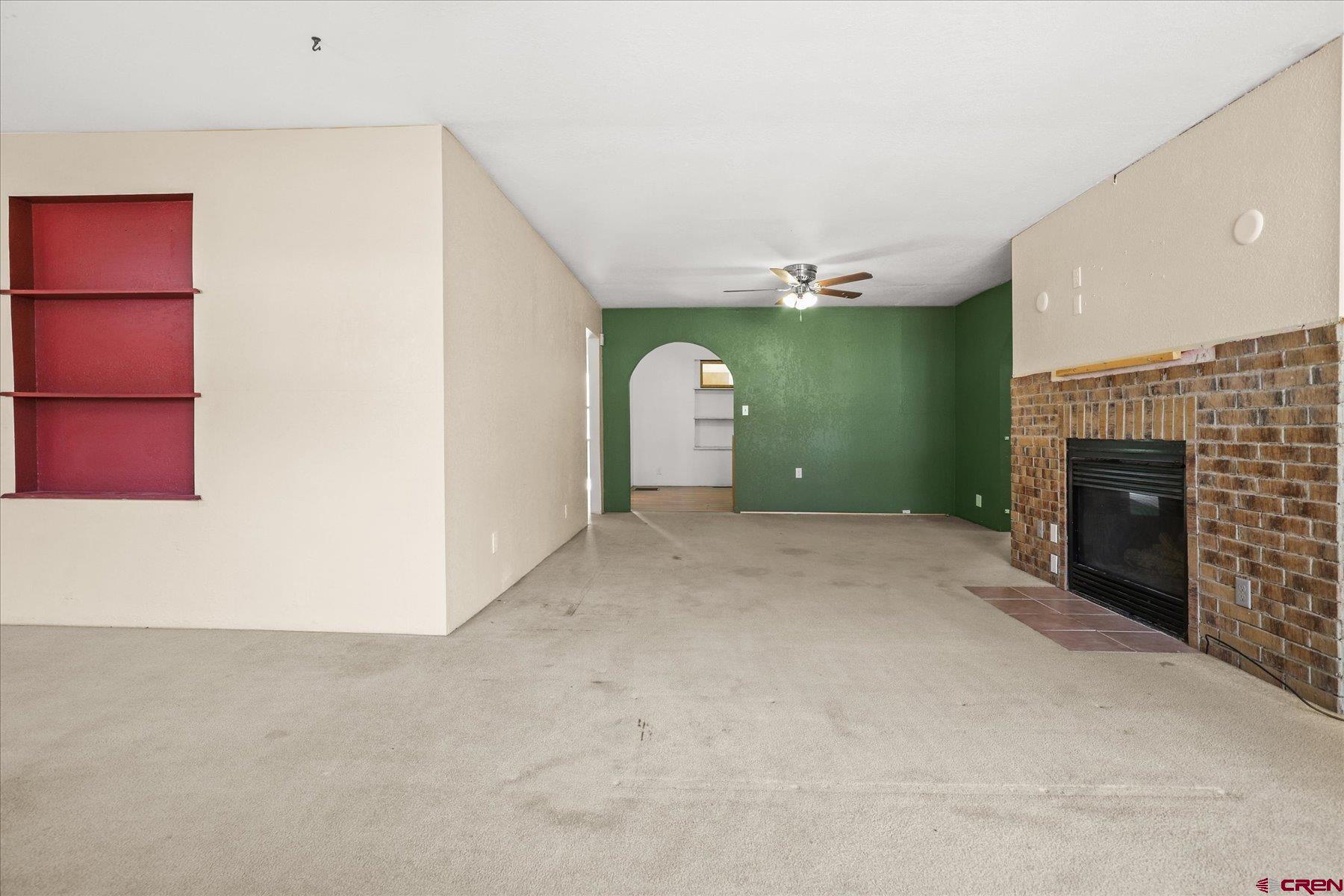 403 East 3rd Street Cortez, CO 81321 - Photo 3 of 31 a view of a livingroom with an empty space and a fireplace