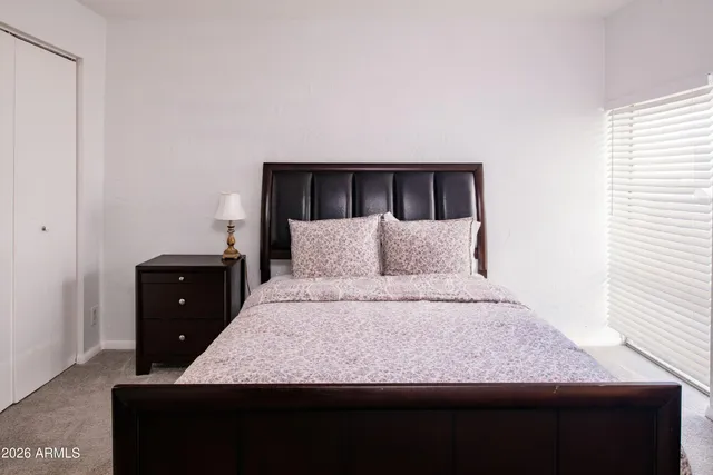 a bathroom with a sink vanity mirror and toilet