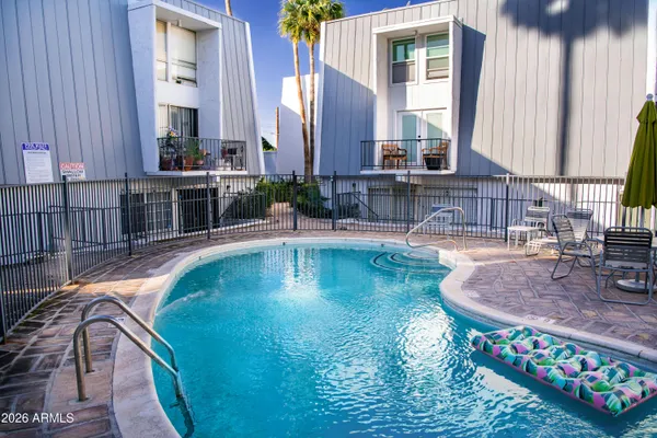 a view of a backyard with a table and chairs under an umbrella