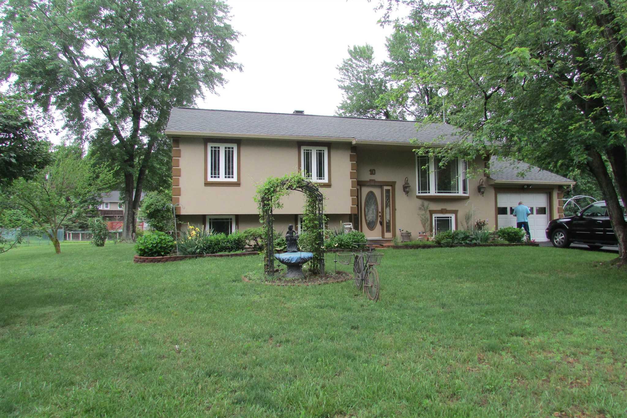 a front view of house with a garden and patio