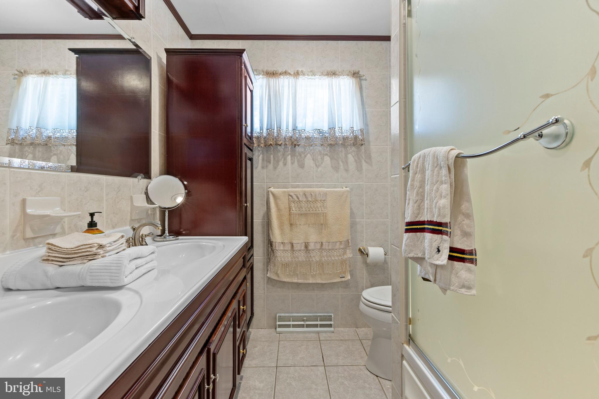 1008 Rosedale Avenue Baltimore, MD 21237 - Photo 21 of 45 a bathroom with a granite countertop sink toilet and shower