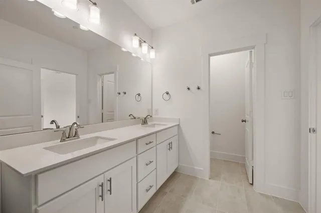 a spacious bathroom with a double vanity sink mirror and