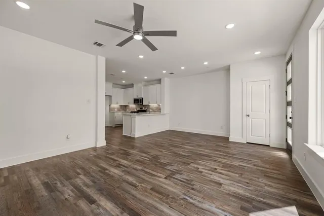 a view of a kitchen with a sink and a refrigerator