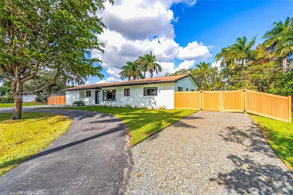 a front view of a house with a yard and a garage