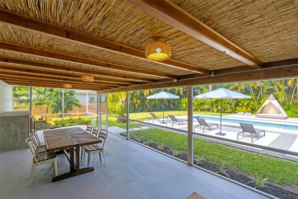a view of a house with small yard and sitting area