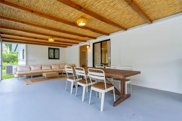 a swimming pool with outdoor seating yard and potted plants
