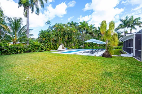 a view of a swimming pool with a yard