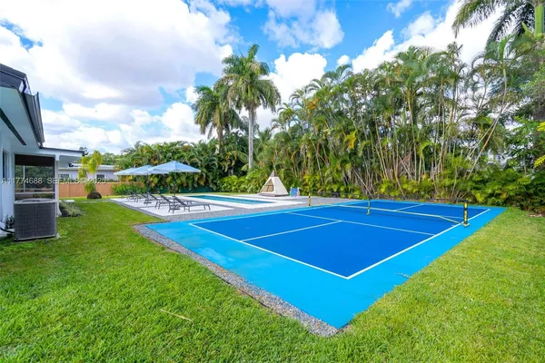 an aerial view of residential house with outdoor space and swimming pool