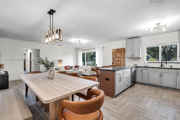 a kitchen with stainless steel appliances granite countertop a sink stove and cabinets